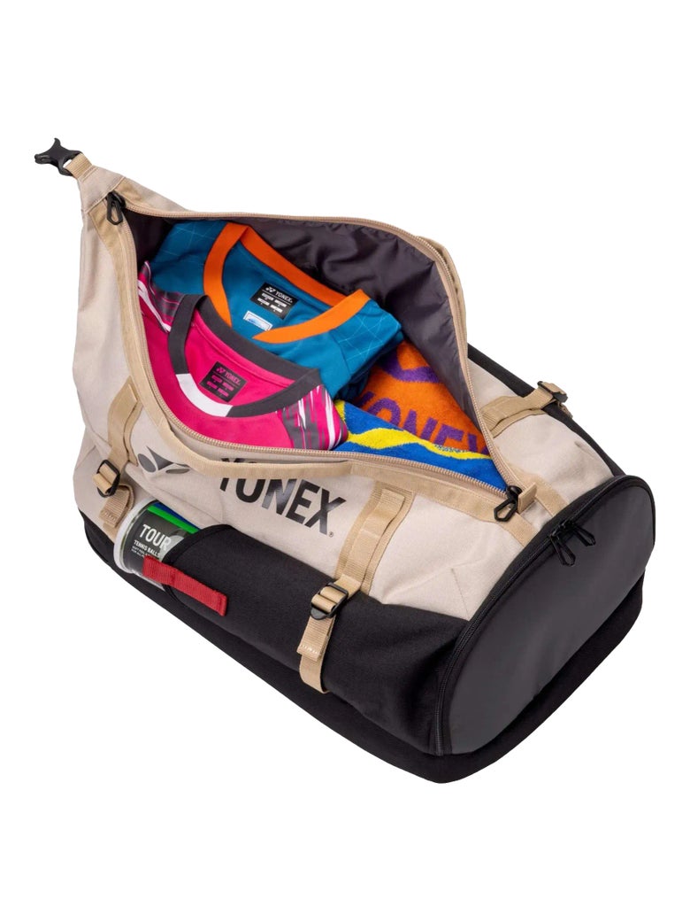 The Yonex Gearlogic Backpack lying down like a duffel bag filled with clothes