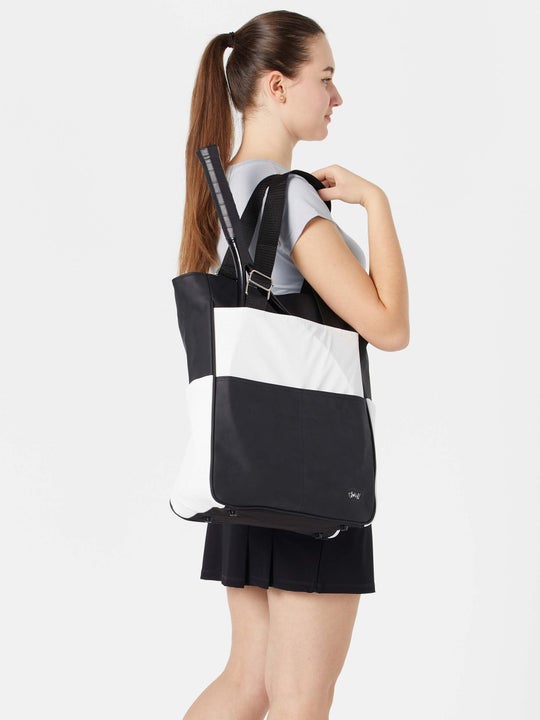 Model carrying the Glove It Signature Tennis Tote in black/white