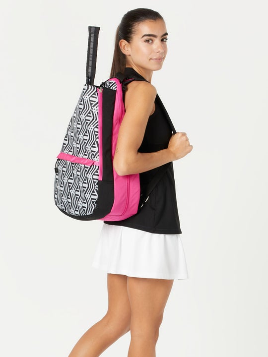 Image of model carrying the Glove It Tennis Backpack in a white/black/pink print