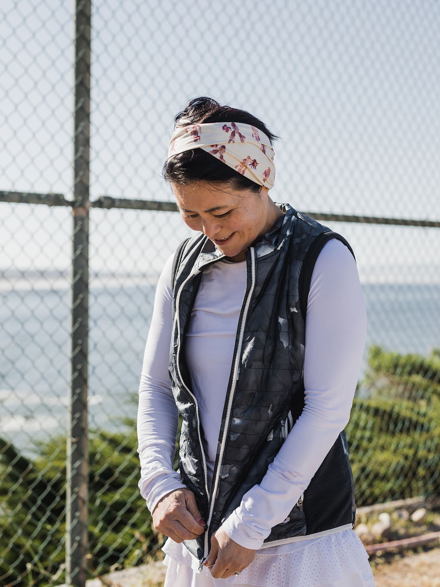 Image of a tennis player wearing a warm-up jacket. 
