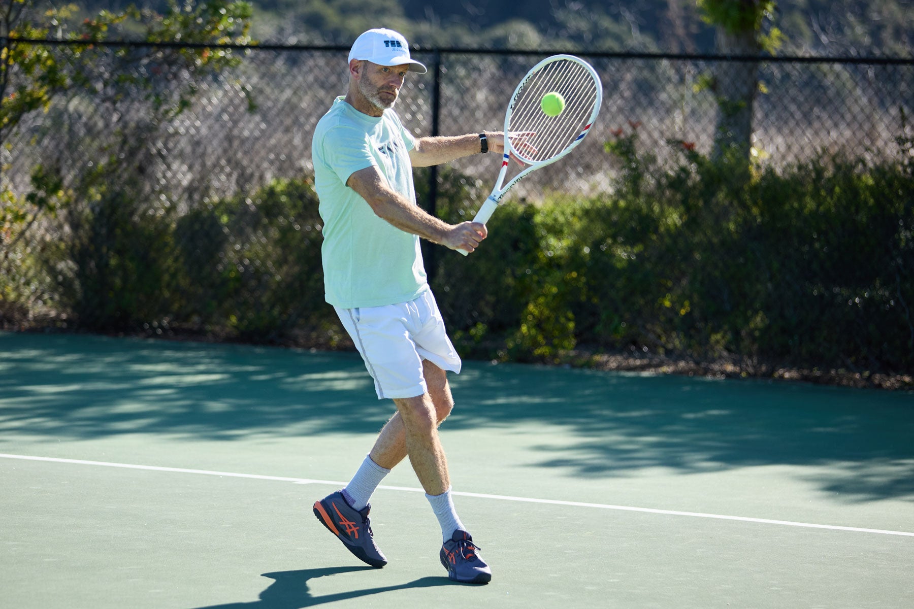 TW playtester hitting a backhand slice.