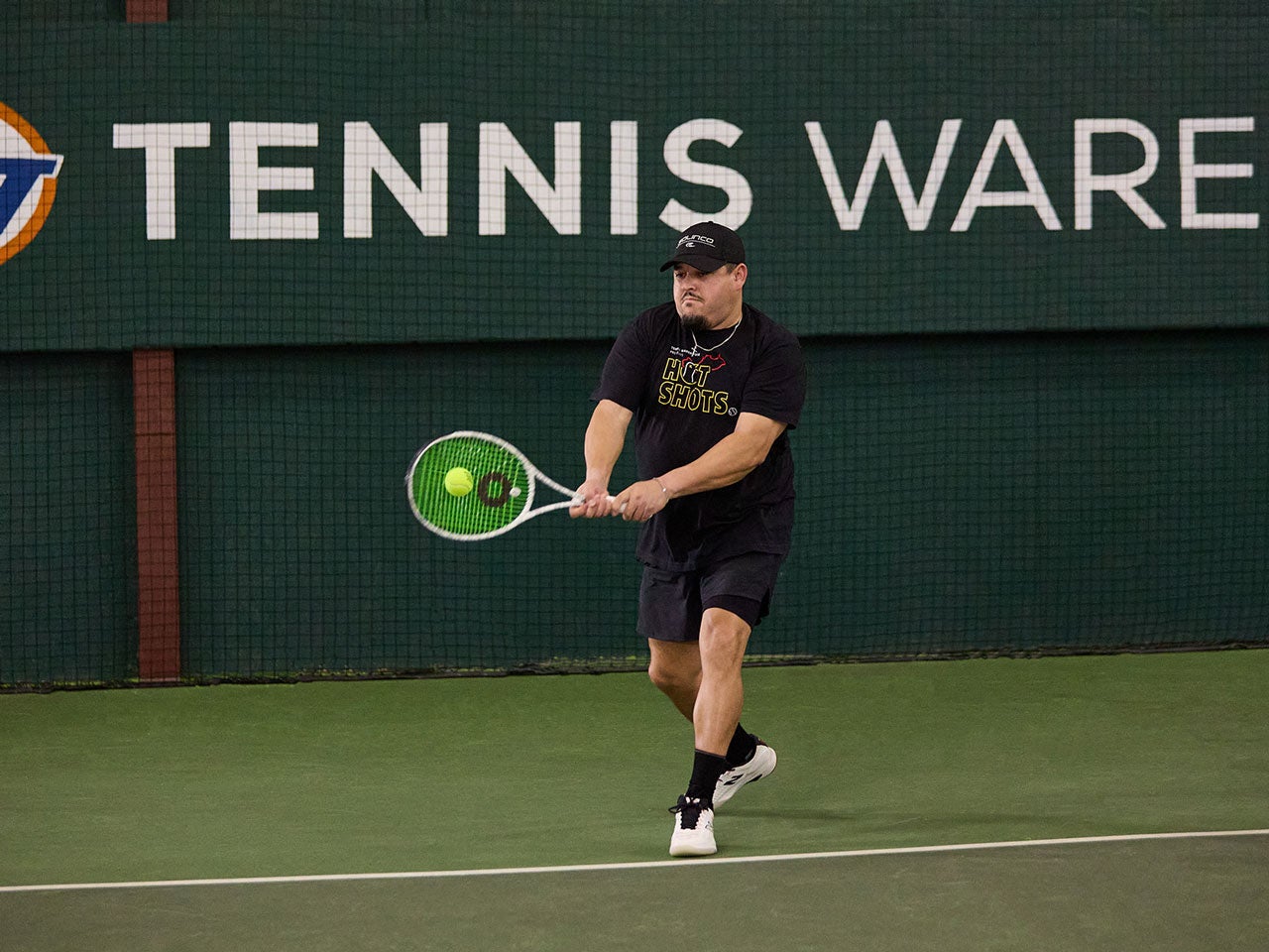 TW playtester hitting a backhand with the Solinco Whiteout 305 18x20.