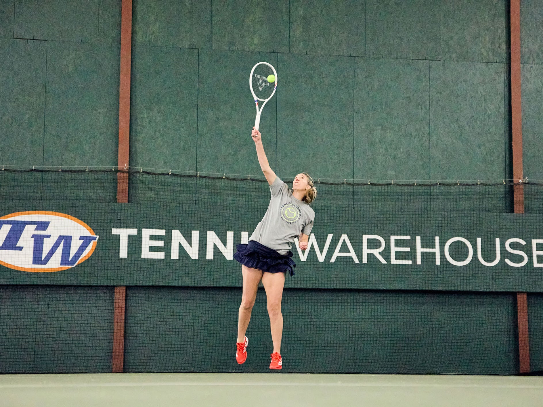 TW playtester hitting a serve with the TFight 300. 