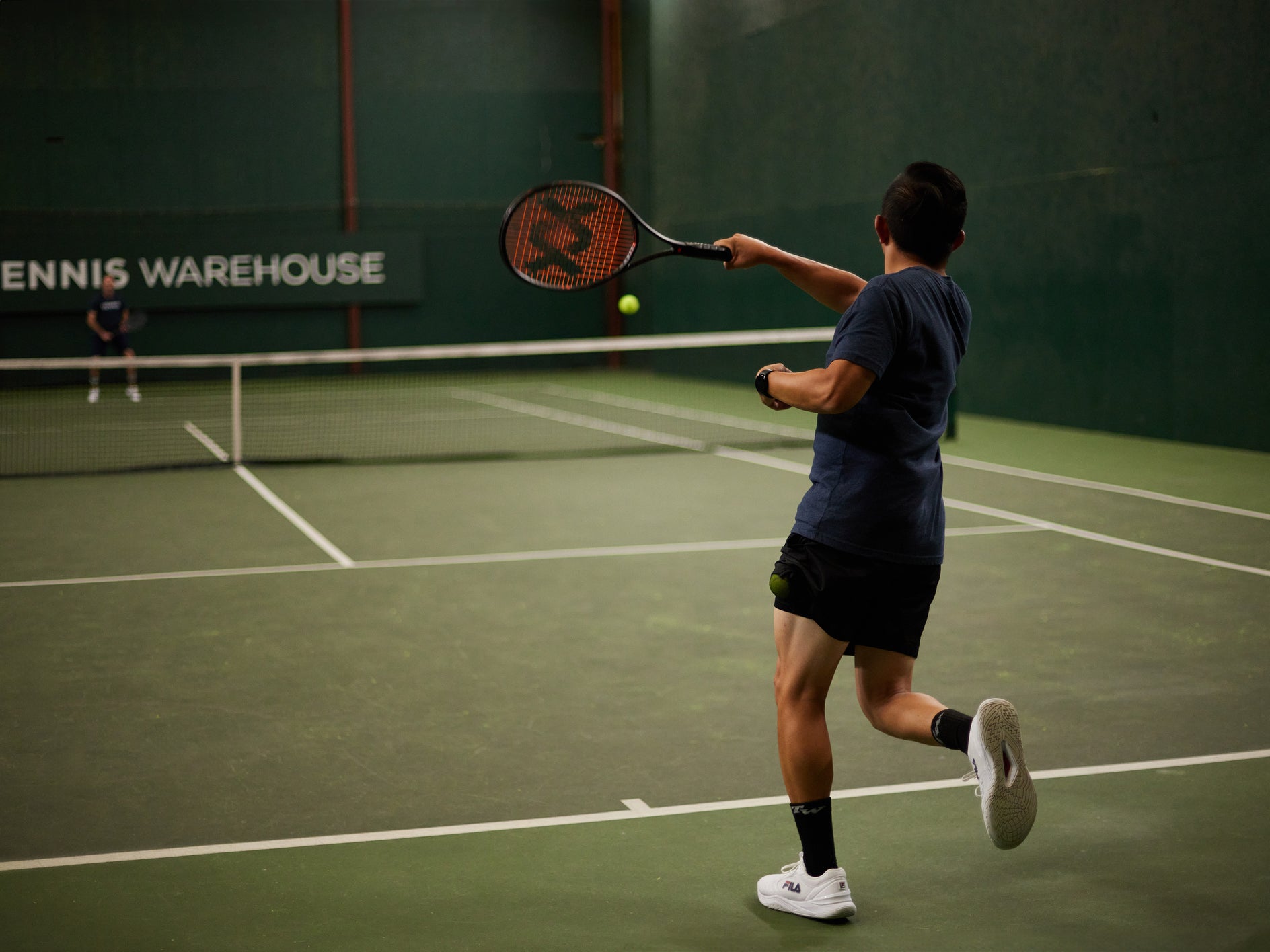 TW playtester hitting a forehand with the Vostra V9 305g. 