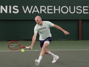 Image of a TW playtester serving and volleying. 