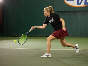 Image of a TW playtester hitting a forehand on the stretch. 