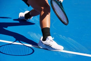 Image of Tennis Shoes Sliding Across Court