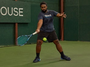 Image of a TW playtester stepping into a forehand. 