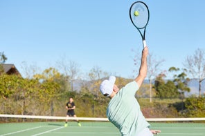 Image of a TW Playtester hitting a serve. 