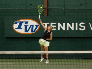 Image of a TW playtester hitting a serve.