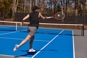 Image of a TW playtester hitting a forehand. 