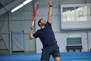 Image of a TW playtester hitting a serve. 