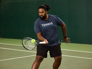 Image of a TW playtester hitting a volley. 