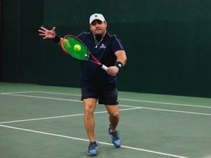 Image of a Playtester Hitting a Backhand Volley