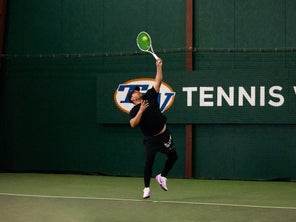 Image of playtester hitting a serve