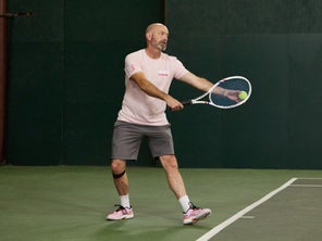 Image of a TW playtester hitting a serve. 