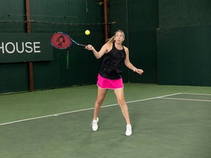 Image of a TW playtester hitting a forehand. 