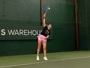 Image of a TW playtester hitting a serve.