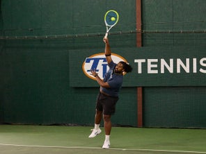 Image of a TW playtester hitting a serve. 