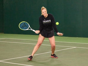 Image of a TW playtester hitting a volley. 