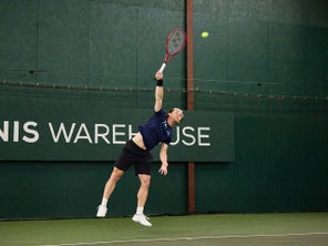 TW playtester hitting a serve. 