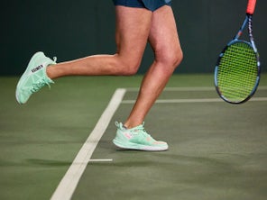 Image of a Playtester's Legs Hitting a Serve