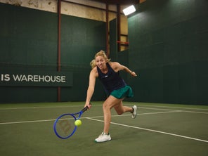 Image of a TW playtester hitting a stretch volley. 