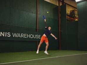 Image of a TW playtester hitting a serve. 