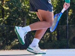 Image of a Playtester's Legs Hitting a Serve