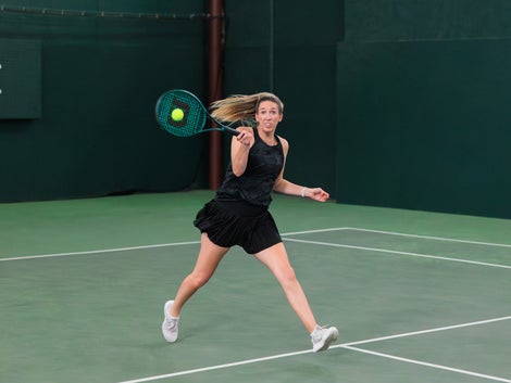 Brittany blasts a forehand with the Blade 100. 