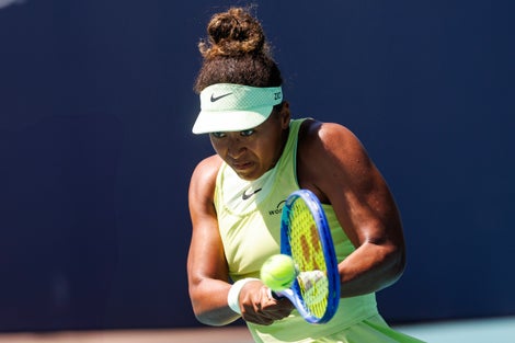 Image of Naomi Osaka following through. 