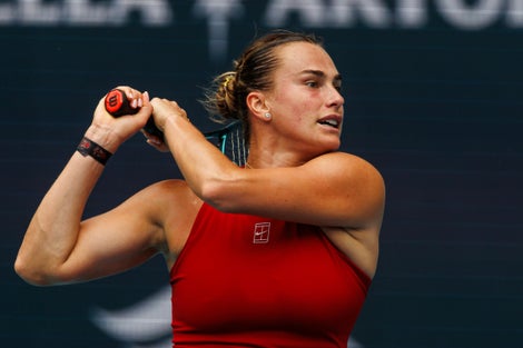 Image of Aryna Sabalenka following through a backhand. 
