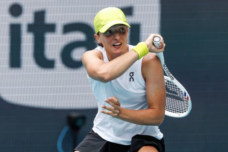 Image of Iga Swiatek following through a shot. 