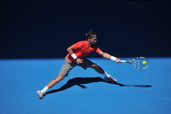 Nadal reaches out wide for a forehand.