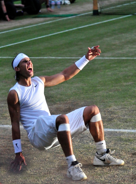 Nadal falls to the ground after winning the 2008 Wimbledon final. 