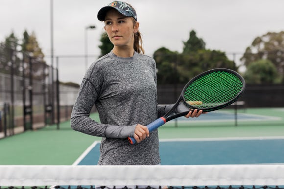 Image of tennis player in long sleeves