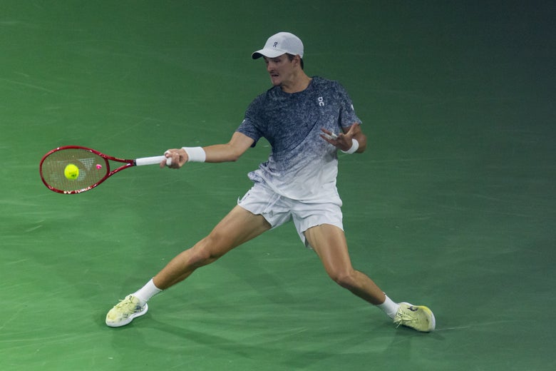 Image of Joao Fonseca sliding into a forehand. 