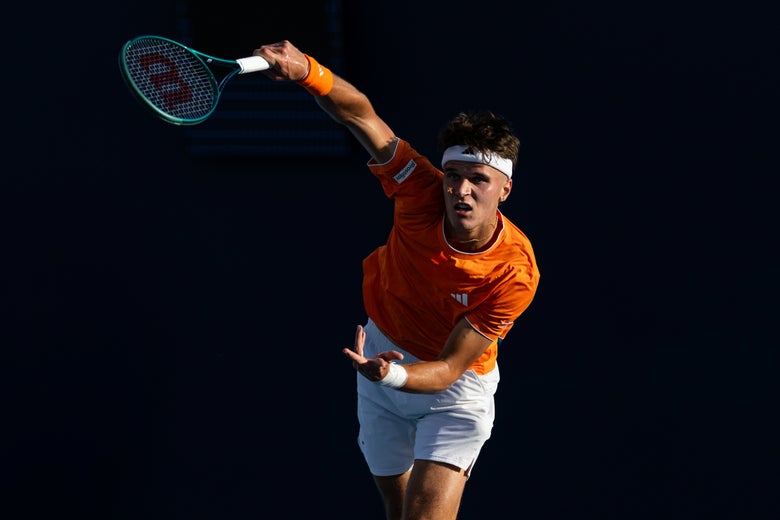Image of Jakub Mensik hitting a heavy serve. 