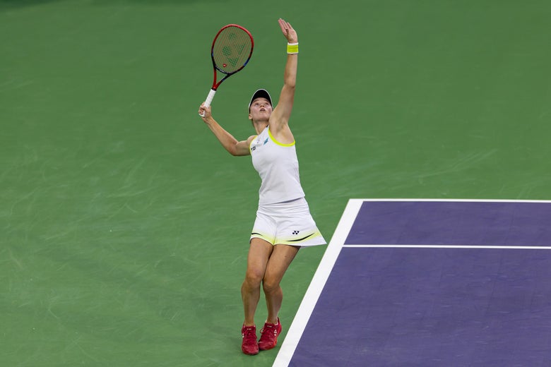 Image of Elena Rybakina in motion for her serve. 