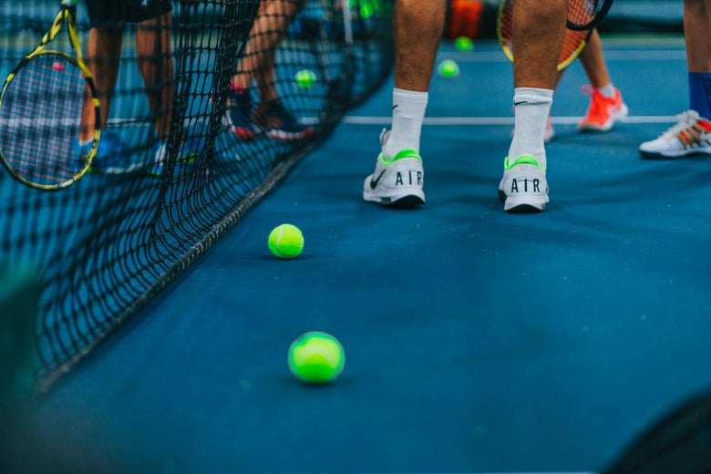 Image of a tennis group playing tennis. 