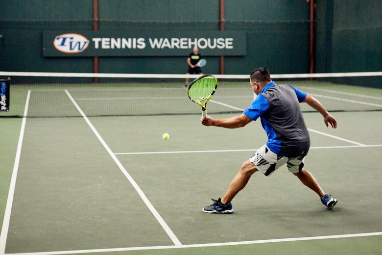 Image of tennis player on a hard court