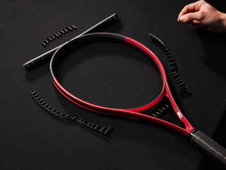 Image of a Racquet with New Grommets Laid Out in Place