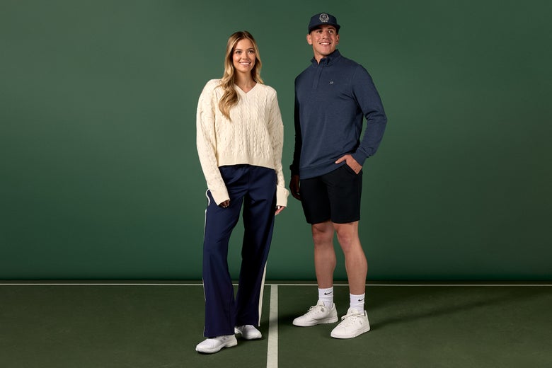 Woman in cable knit sweater with pants and man wearing baseball cap, quarter zip and shorts.
