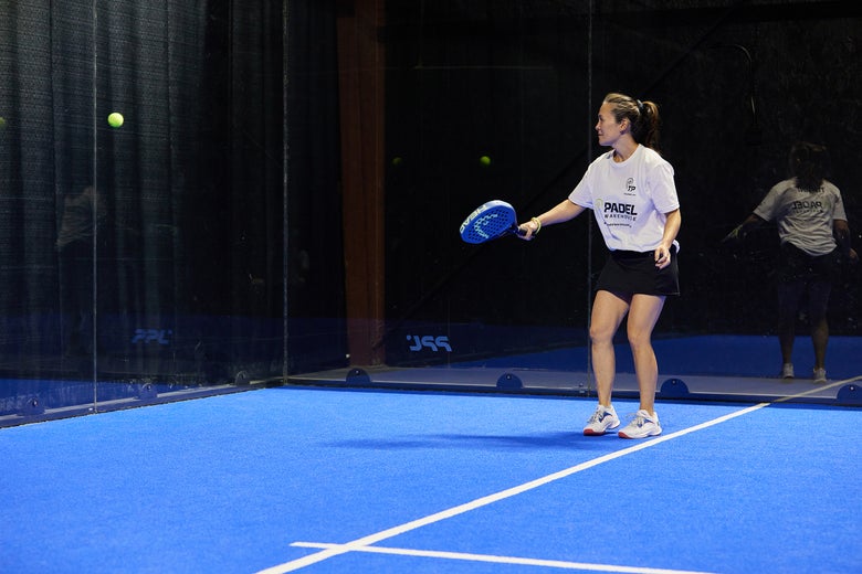 Image of a Padel Warehouse playtester letting a ball rebound off the back glass. 