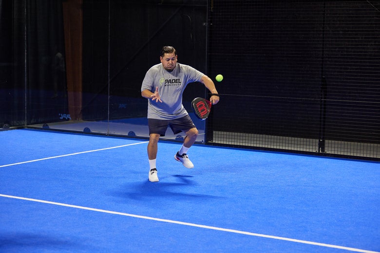 Image of a Padel Warehouse playtester hitting a volley. 