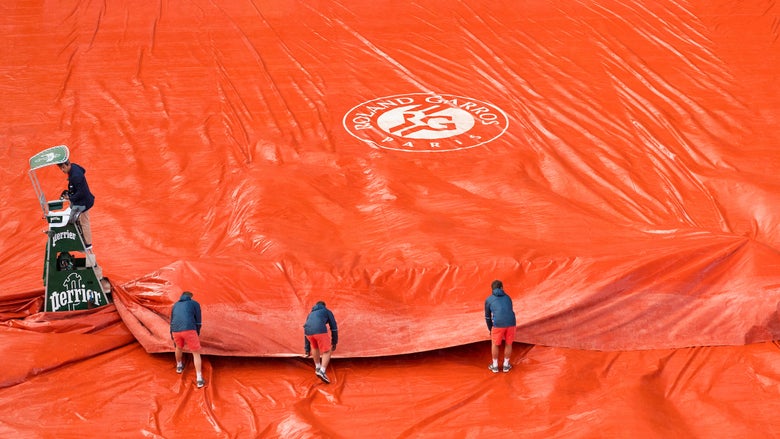 Roland Garros courts being covered by tarps in the rain