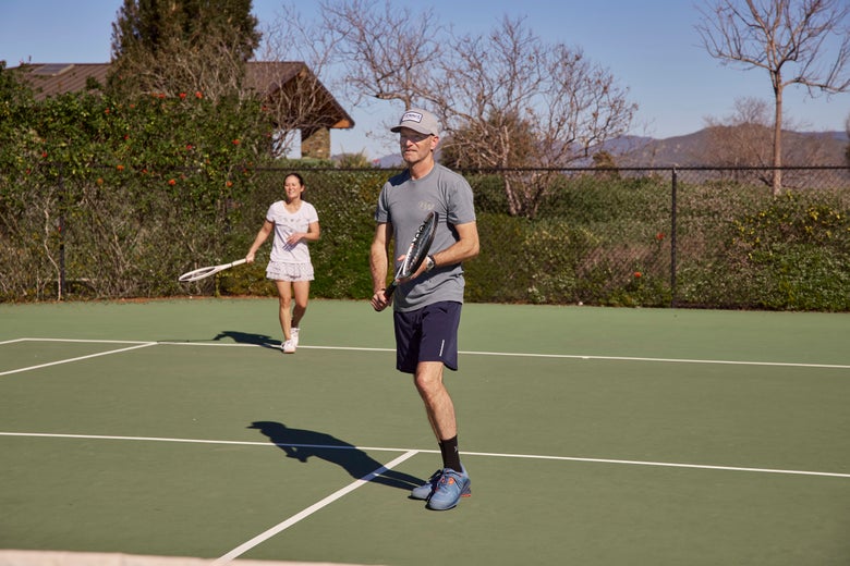 Image of a mixed doubles team with the man wearing a ball cap