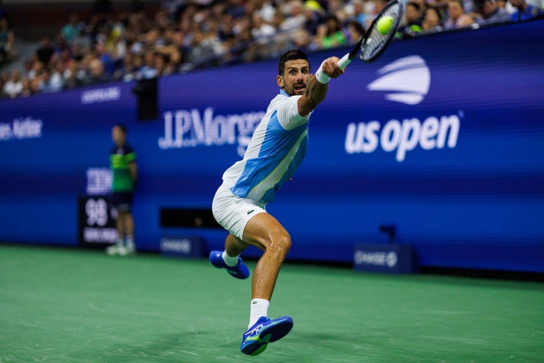 Djokovic reaches for a backhand. 