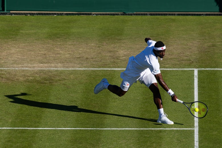 Frances Tiafoe digs out a low ball. 