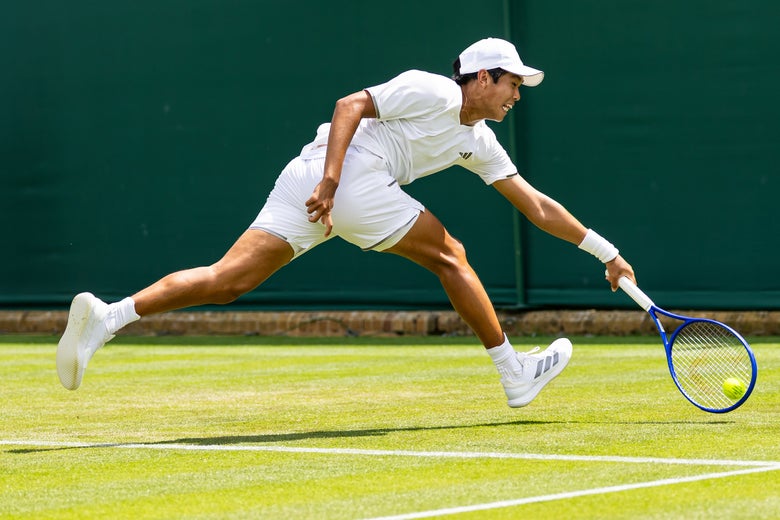 Learner Tien stretches for a forehand on the run. 